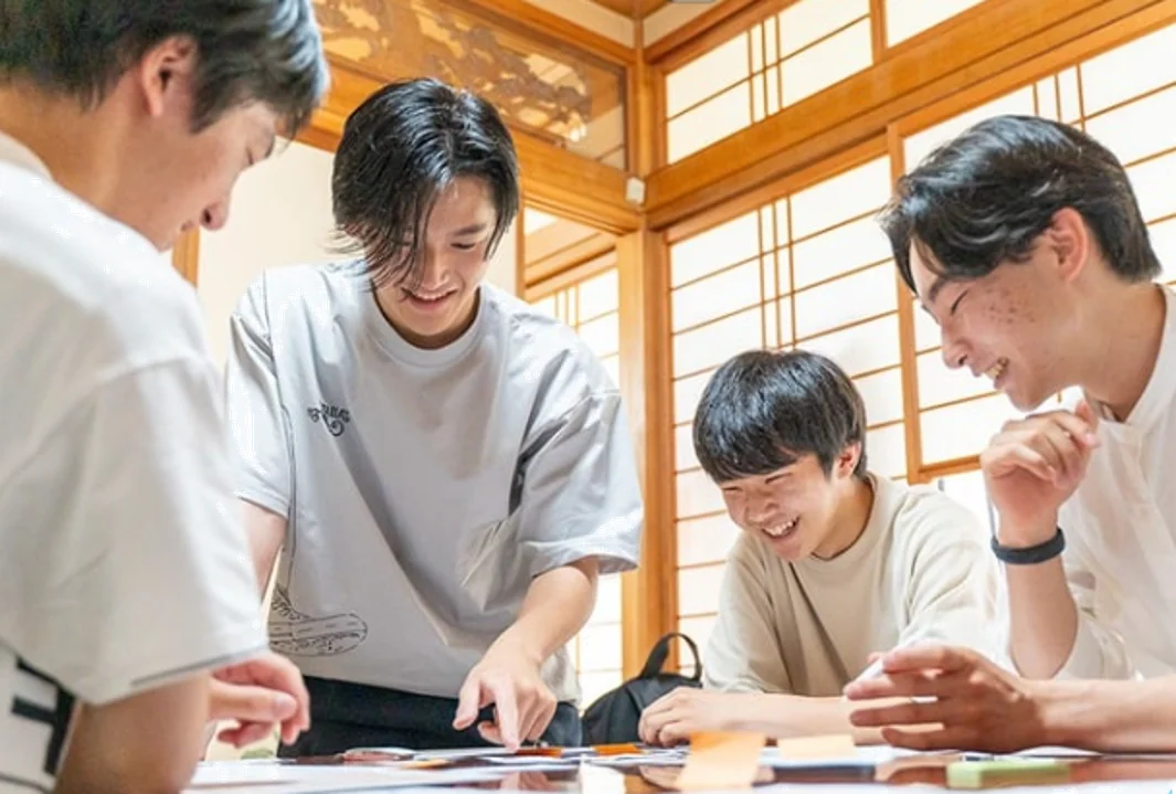 カードを並べて楽しそうに話し合う若者たち